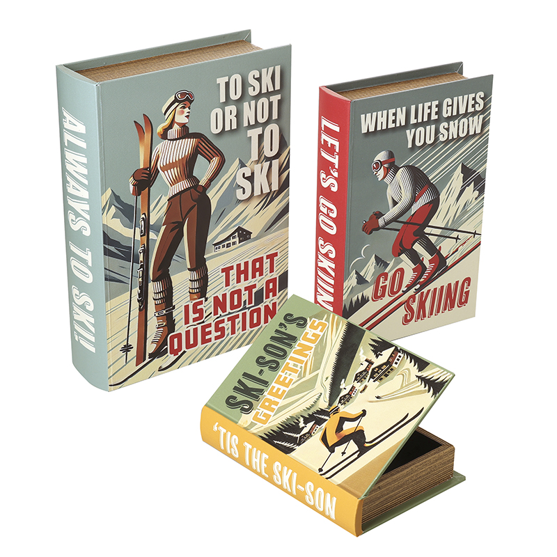 Christmas Ski Book Christmas Gift Boxes Set Of 3 by Heaven Sends<br><br> Add a playful Alpine twist to your Christmas gifting and home styling with this charming Set of 3 Christmas Ski Book Gift Boxes by Heaven Sends. Designed to look like vintage hardback books these decorative storage boxes celebrate the golden age of ski resorts with bold retro artwork witty ski slogans and beautiful seasonal colours.<br><br> Presented as a set of three graduated sizes these gift boxes stack beautifully together or can be dotted around your home to tie a whole room into a cosy ski chalet theme. A brilliant present for skiing enthusiasts travellers and lovers of vintage Christmas decor who appreciate a little humour with their festivities.